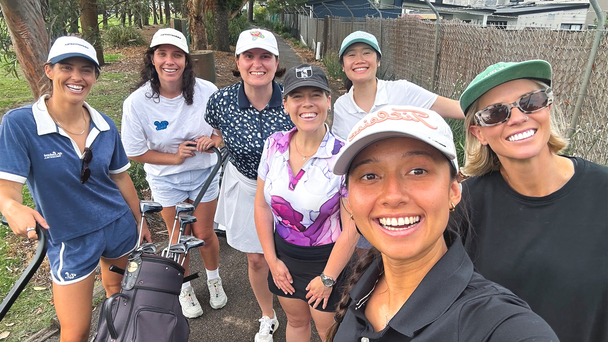 Group of women posing for a selfie on a golf course