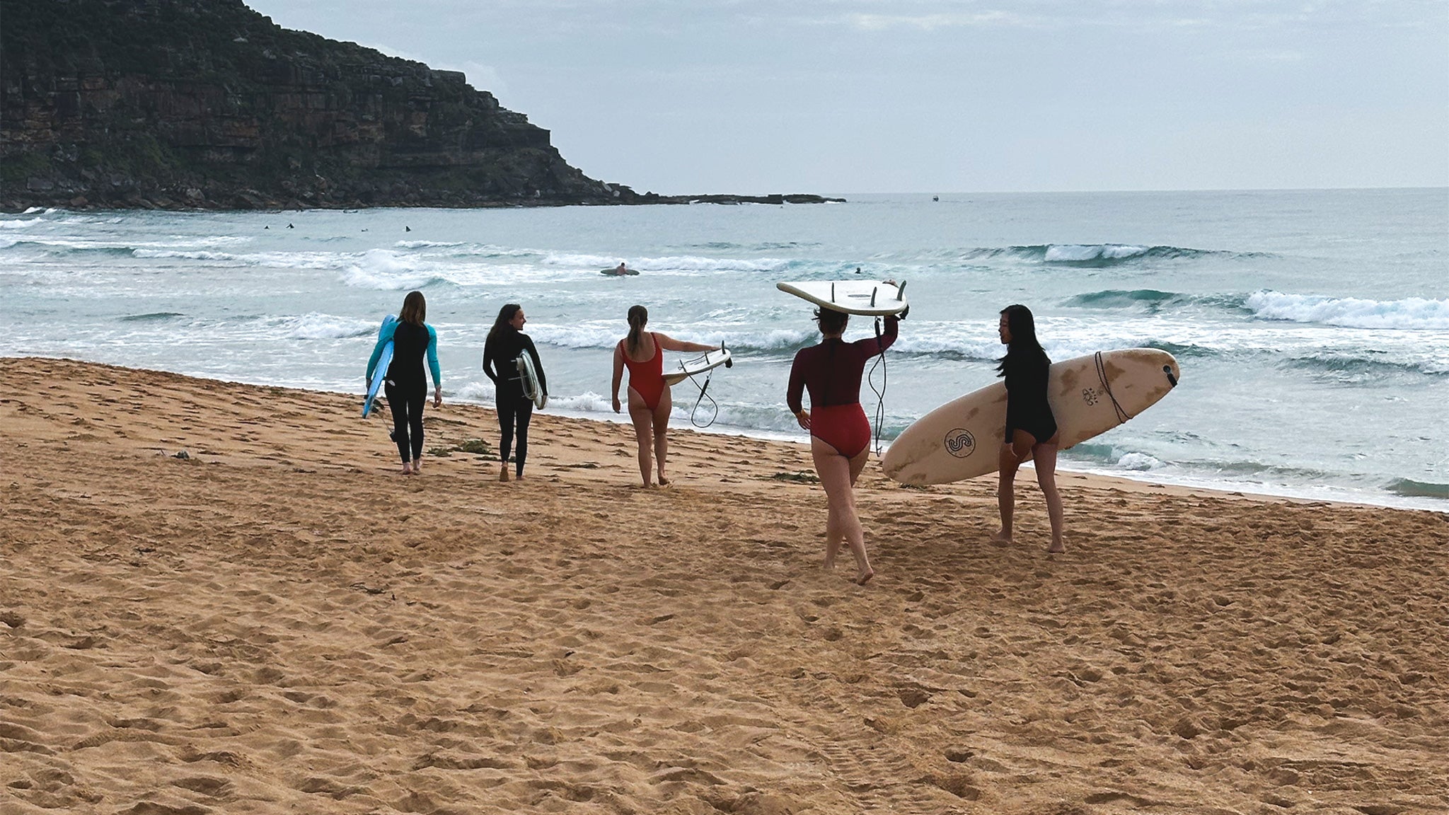 Group of people with surfboards on a beach